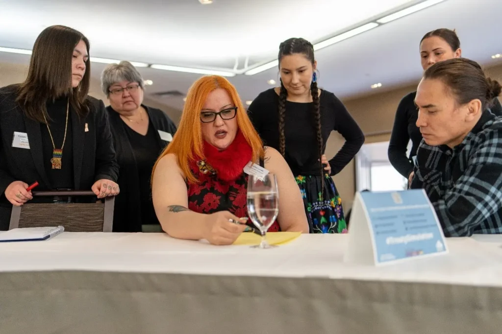 Advisor Lisa Hutton (second left) working with participants during the negotiations.  